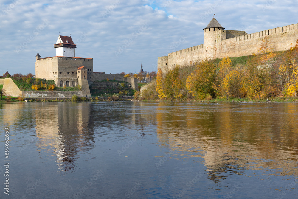 Ancient Herman's castle and Ivangorod fortress on the border river Narva on a sunny October day. Border between Russia and Estonia