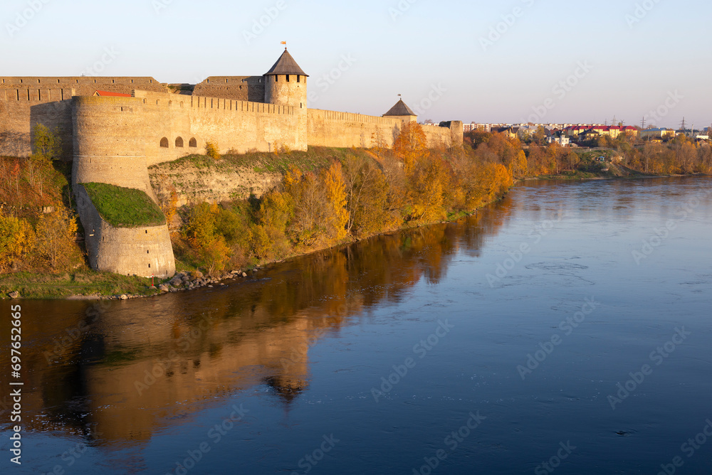 Ivangorod fortress above the border river Narva on a sunny October evening. Leningrad region, border of Russia and Estonia