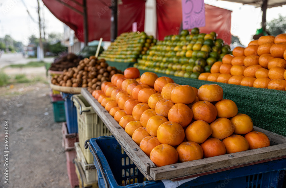 Close-up view of many ripe yellow orange fruits stacked in rows in trays. Close-up view of many ripe yellow orange fruits stacked in rows in trays.