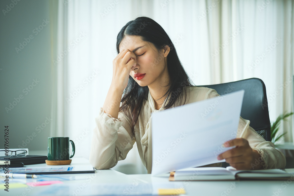 Stressed female employee feeling tired at work, suffering from headache, stress at work or migraine. Stressed female employee feeling tired at work, suffering from headache, stress at work or migraine.
