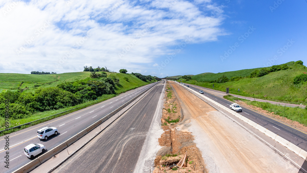 Driving Road Highway Overhead New Construction Expansion Of Vehicle Lanes in Countryside Landscape. Driving Road Highway Overhead New Construction Expansion Of Vehicle Lanes in Countryside Landscape.