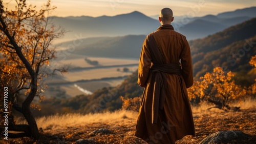 Monk looking at the landscape on top of a mountain