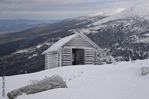 Winter landscape with wooden house