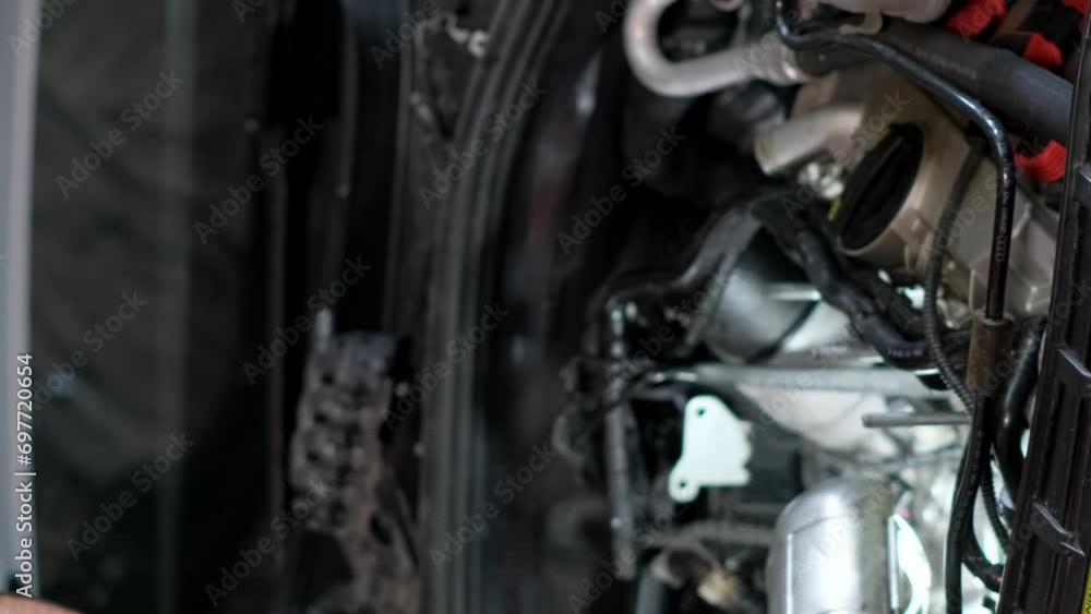 Auto car repair service center. Mechanic examining car engine. Vertical video Auto car repair service center. Mechanic examining car engine. Vertical video