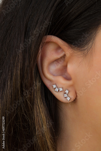 Woman wearing beautiful stud earrings with zirconia.
