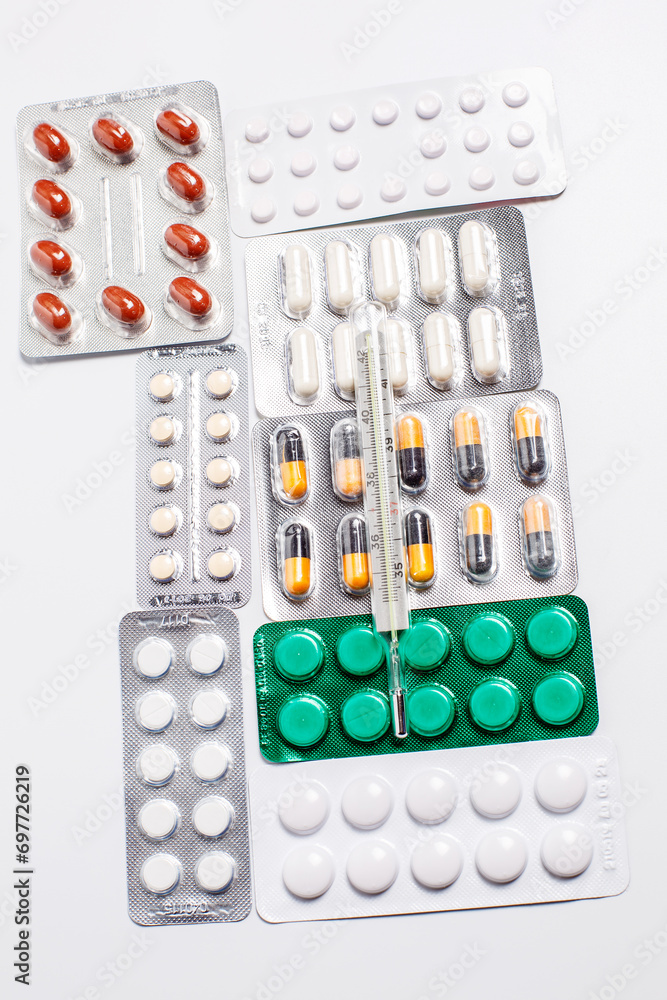 Different tablets for treatment and a thermometer for measuring body temperature, medicine Different tablets for treatment and a thermometer for measuring body temperature, medicine