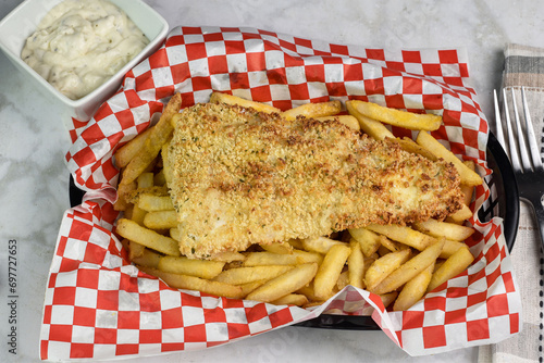 baked haddoc  on fries with tarter sauce photo