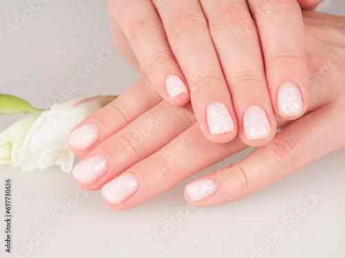 Women s manicure shellac soft pink color close-up