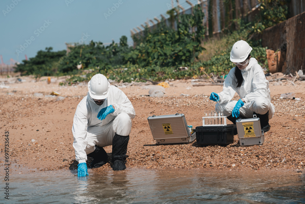 Scientist wear protection suit checking chemical and water analysis and water quality from factory. Protecting Against Hazards and Contamination. Scientist wear protection suit checking chemical and water analysis and water quality from factory. Protecting Against Hazards and Contamination.