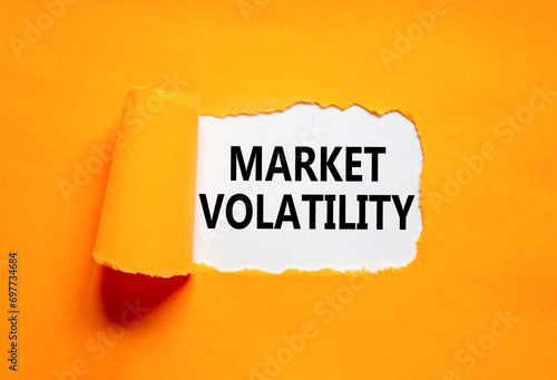 Market volatility symbol. Concept words Market volatility on beautiful white paper. Beautiful orange paper background. Business market volatility concept. Copy space.orange