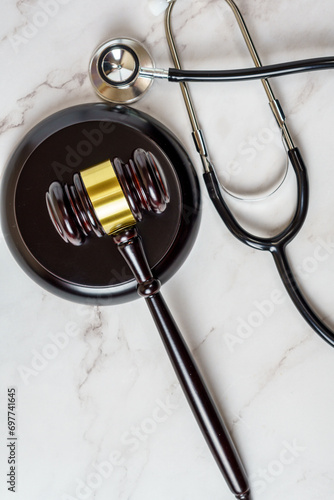 A judge's gavel and a physician's stethoscope. access and entitlement to health care regardless of race, religion, ethnicity, socioeconomic status photo