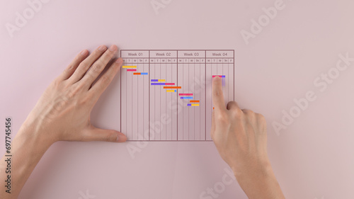Businessman checks and manages his weekly schedule on a table.