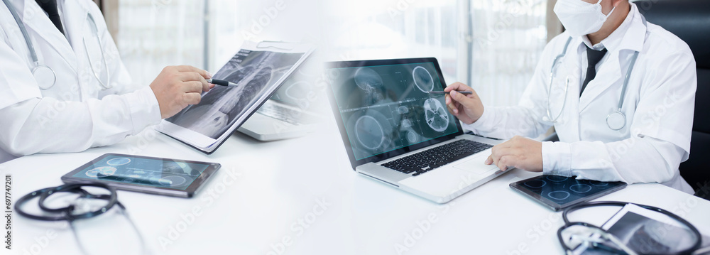 doctor looking at the ray, Doctor with film x-ray sheet and working at desk in hospital, Health care and medicine concept. doctor looking at the ray, Doctor with film x-ray sheet and working at desk in hospital, Health care and medicine concept.