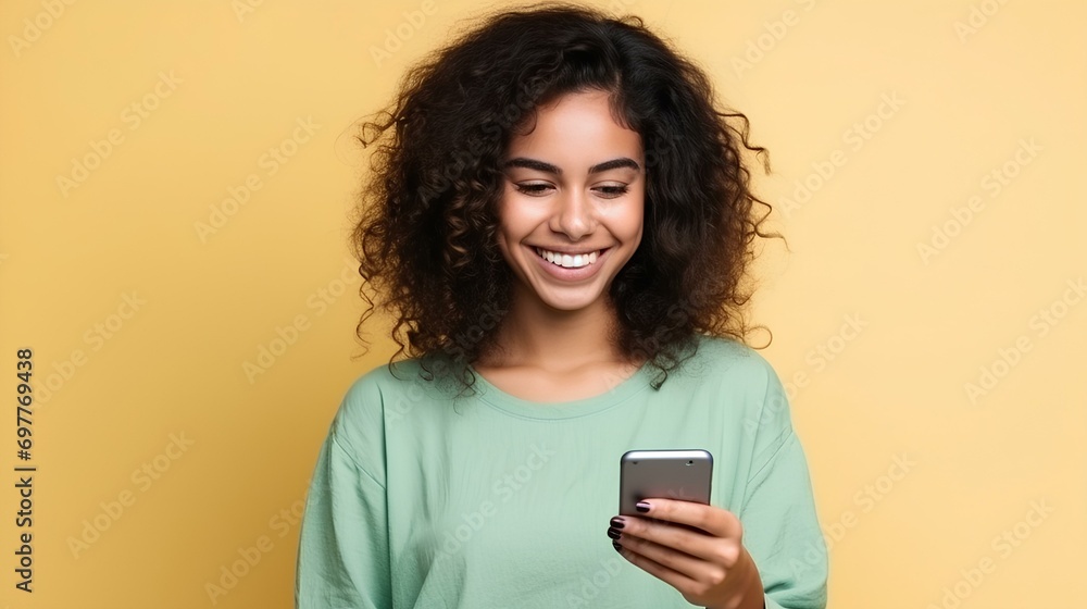 Girl with dark curly hair and brown skin holds a cell phone Girl with dark curly hair and brown skin holds a cell phone