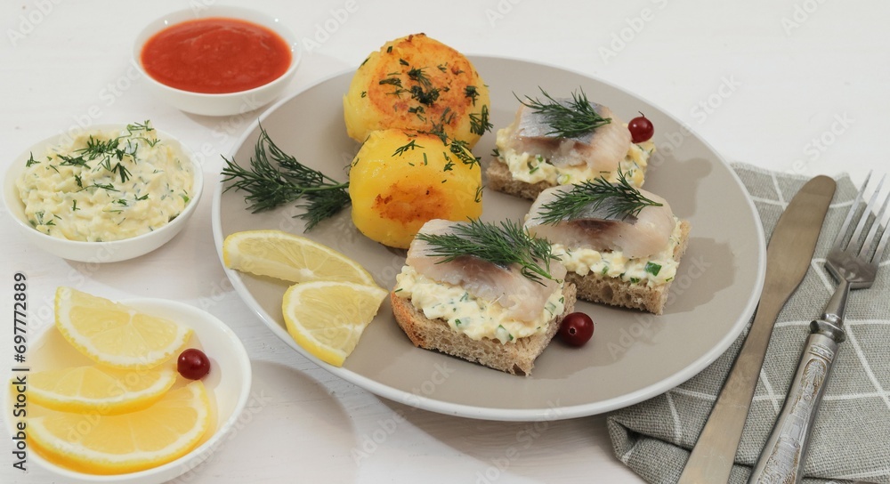 herring and potatoes, lemon in a saucer herring and potatoes, lemon in a saucer