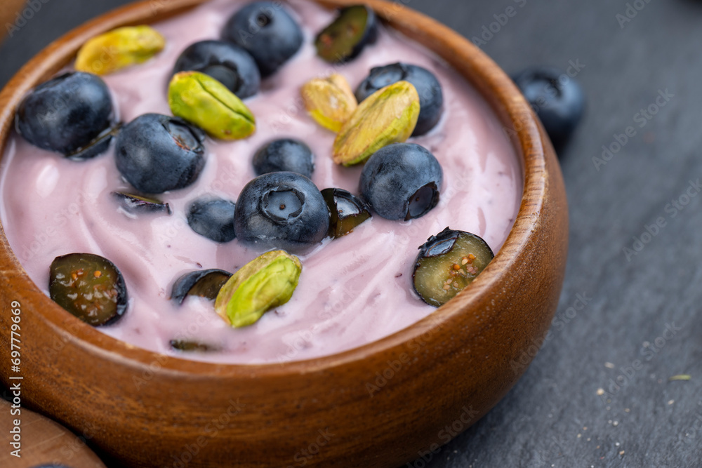 fresh blueberry-flavored yogurt with ripe blueberries and pistachios fresh blueberry-flavored yogurt with ripe blueberries and pistachios