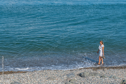 Coastal Charm: Girl in White Dress by the Sea