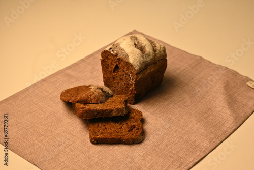 Sliced black bread on a grey background, loaf of black borodish fresh bread, healthy bread 	 photo