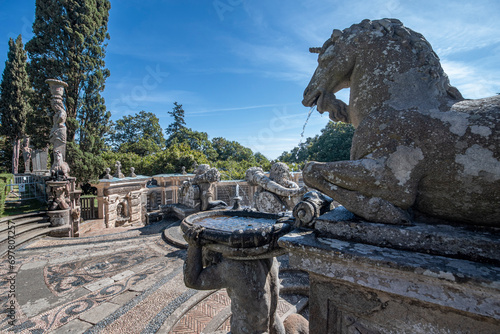 Caprarola, Viterbo, Italy - 2023, September 12: The large fountain called Fontana del Bicchiere by Giacomo del Duca. Horse statue detail. It is located in the high garden of Palazzo Farnese..