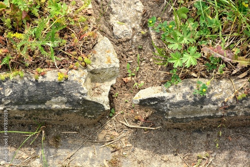 Damaged concrete curb by the sidewalk