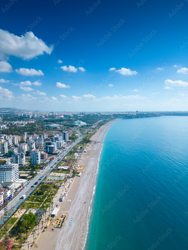 Awesome view of Konyaalti Beach and Park in Antalya, Turkey. Drone flying over the beach. Konyaalti Beach is a popular tourist attraction in Turkey.