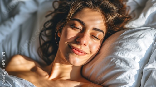 a woman laying in bed and smiling