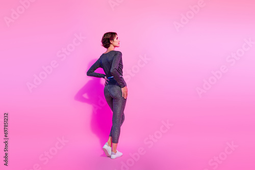 Full length photo of slim shiny lady wear glamour overall looking empty space isolated pink color background