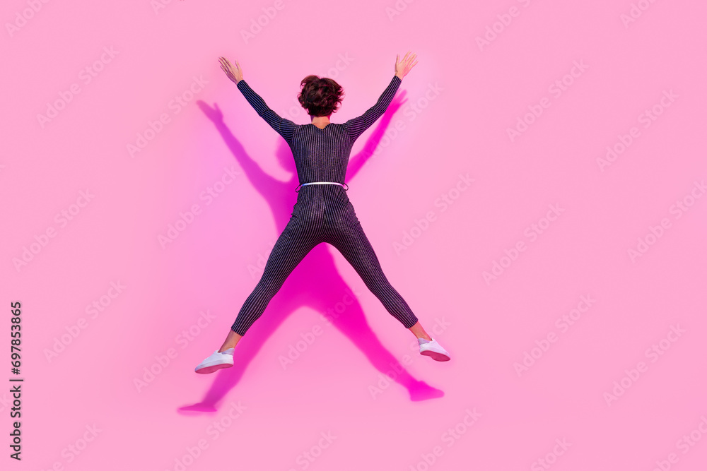 Full length photo of funny funky lady wear glamour overall jumping high like star empty space isolated pink color background