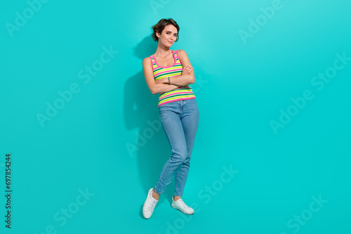 Full size portrait of lovely positive girl crossed arms posing isolated on turquoise color background