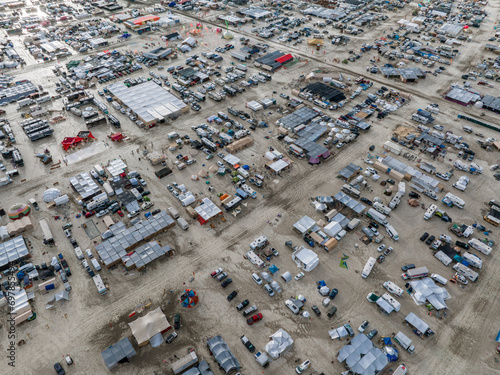 People camping in a desert during a heavy storm. Aerial shot of the camp city from above. photo