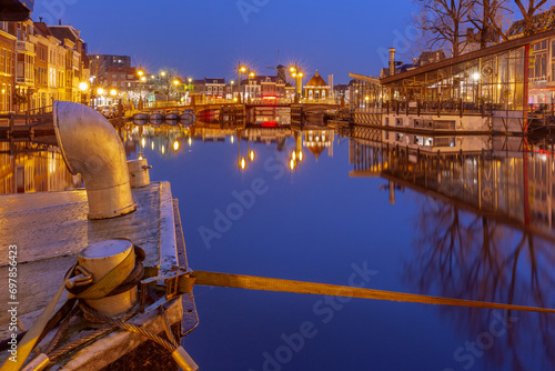 Night Leiden canal with Blauwpoortsbrug bridge and Windmill De Valk, South Holland, Netherlands. photo