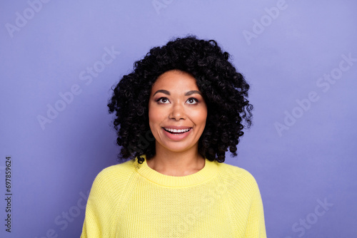 Photo portrait of pretty young girl look up interested empty space dressed stylish yellow outfit isolated on violet color background © deagreez