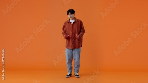 Shy asian man feeling unconfident while being scolded indoor photo