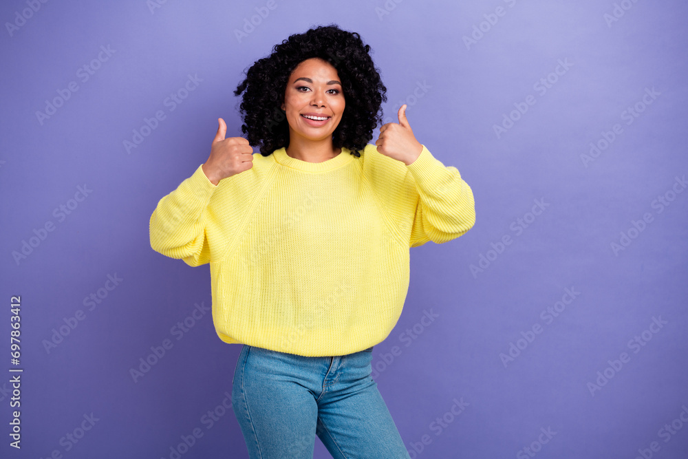 Photo portrait of pretty young girl show double thumb up wear trendy yellow outfit isolated on purple color background Photo portrait of pretty young girl show double thumb up wear trendy yellow outfit isolated on purple color background