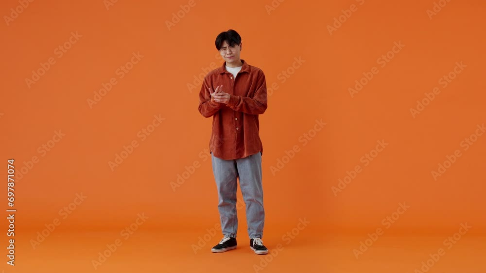Asian guy counting on fingers and crossing arms in studio Asian guy counting on fingers and crossing arms in studio