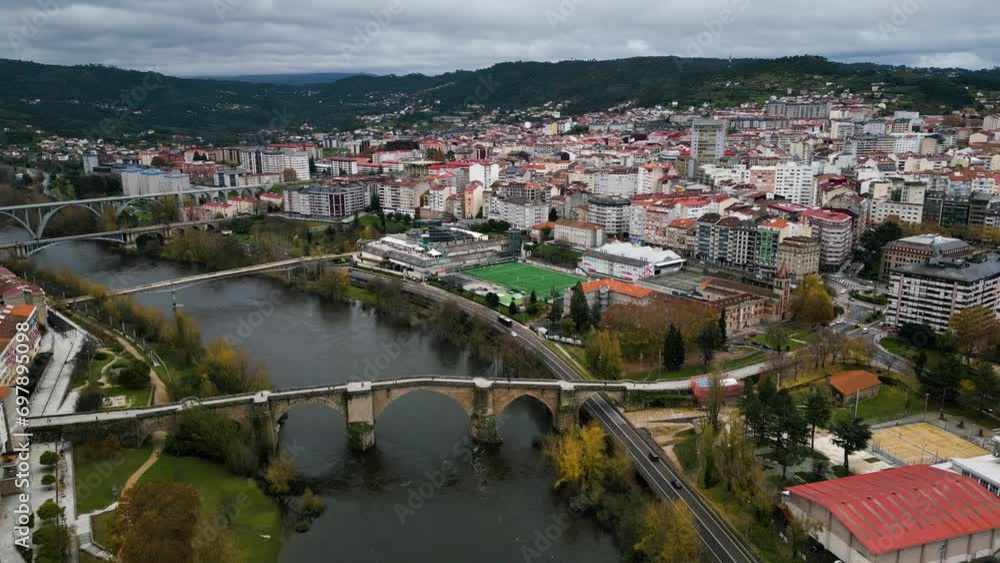 Angled overview of brdiges crossing river with Ourense Roman Bridge on Miño River in Ourense, Galicia, Spain Angled overview of brdiges crossing river with Ourense Roman Bridge on Miño River in Ourense, Galicia, Spain