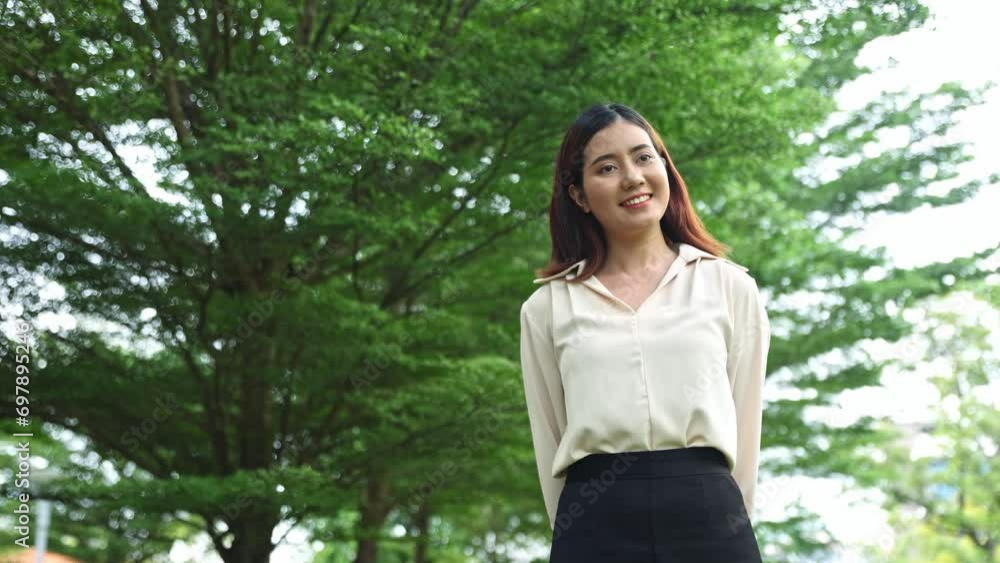 Young asian woman with good health positive emotions standing and embracing ozone fresh air cool breeze beautiful nature shady green trees good air in the park good mental health. Young asian woman with good health positive emotions standing and embracing ozone fresh air cool breeze beautiful nature shady green trees good air in the park good mental health.