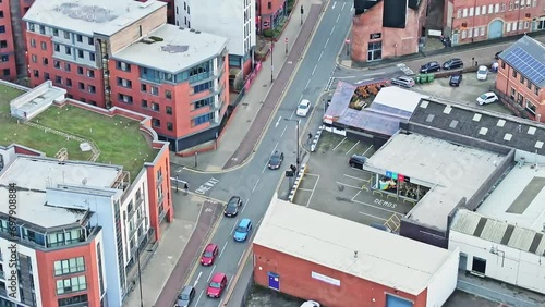 Cars driving into a one way street in the city centre of Sheffield. Drone lowering tilt shot photo