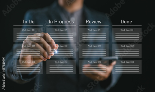 Developer touching virtual interface. Agile software development or project management using kanban or scrum methodology boards on screen. Process, workflow, visual organization tools and framework. photo