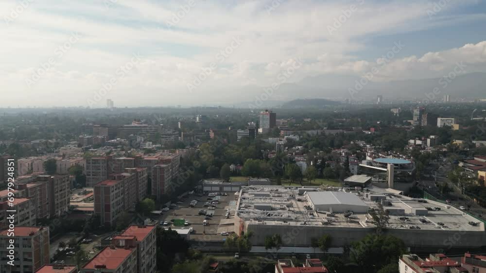 Taking flight drone ascends, revealing the southern expanse of Mexico City, with the iconic Ciudad Universitaria gracing the background Taking flight drone ascends, revealing the southern expanse of Mexico City, with the iconic Ciudad Universitaria gracing the background