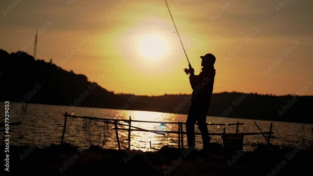 Fishermen are using fishing rods in the reservoir during Silhouette sunset. Fishermen are using fishing rods in the reservoir during Silhouette sunset.