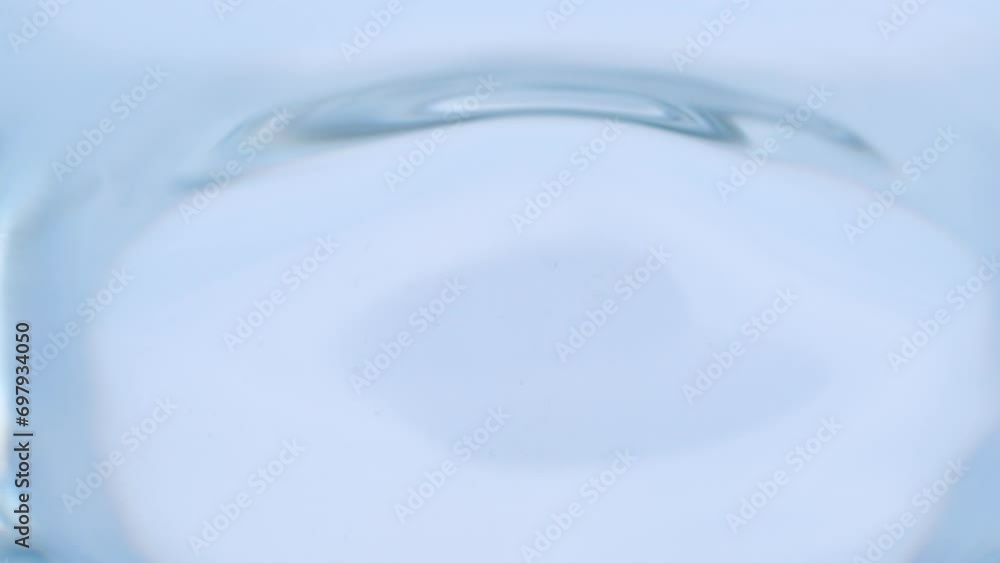 Detail of water drop falling on liquid surface Detail of water drop falling on liquid surface