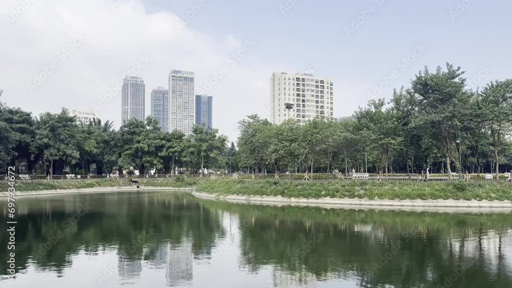 Park and lake in Hanoi Vietnam with city skyline Park and lake in Hanoi Vietnam with city skyline