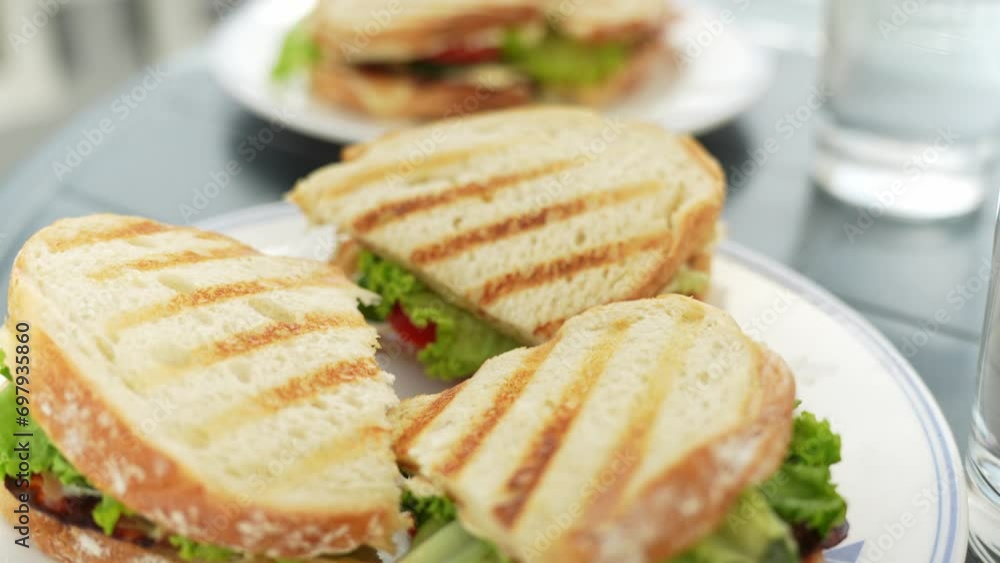 Delicious toast sandwiches with vegetables on white plates, close up Delicious toast sandwiches with vegetables on white plates, close up