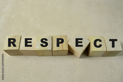 Concept of The wooden Cubes with the word Respect on wooden background.