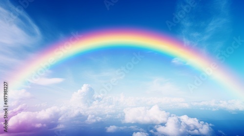 A vibrant rainbow stretching across a clear blue sky