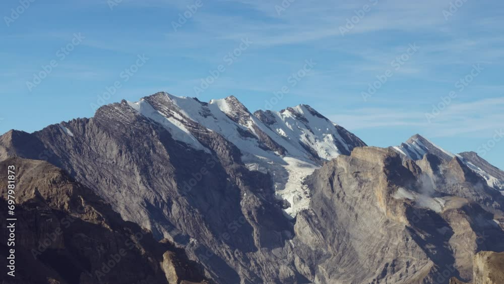 A tranquil blue sky serves as the backdrop for the awe-inspiring mountain scenery, featuring majestic snow-covered peaks that take your breath away. A tranquil blue sky serves as the backdrop for the awe-inspiring mountain scenery, featuring majestic snow-covered peaks that take your breath away.