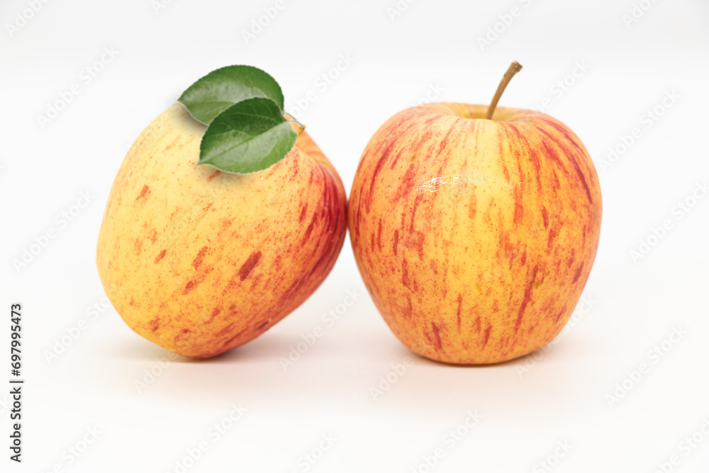 Whole apple with leaves isolated on white background with clipping path and full depth of field