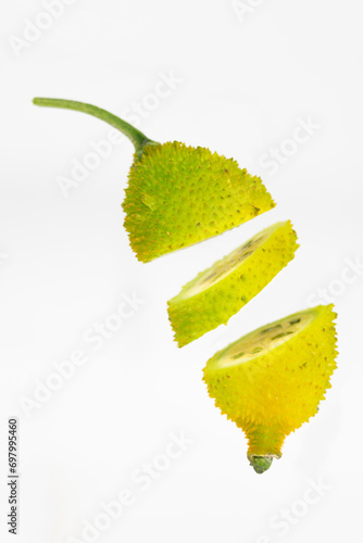 Spiny gourd or spine gourd also known as bristly balsma pear, prickly carolaho isolated on white background photo