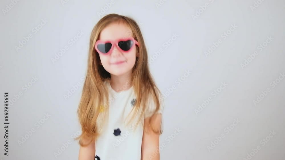 Child enjoyment. Happy child girl screaming with raised hands, white studio background Child enjoyment. Happy child girl screaming with raised hands, white studio background